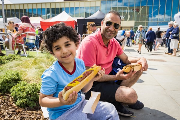 Image Of Child And Parent Enjoying Food At The Food Festival