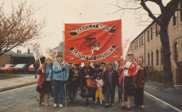 Women against pit closures stood with banner