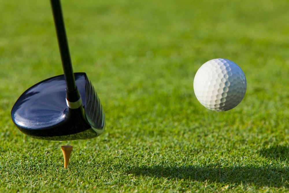 golf club hitting a golf ball