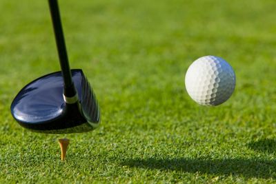 golf club hitting a golf ball
