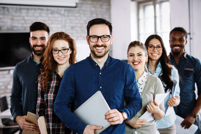 Group of graduates in office