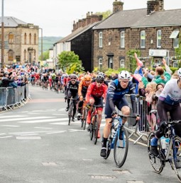 Men racing through Mapplewell for Tour de yorkshire