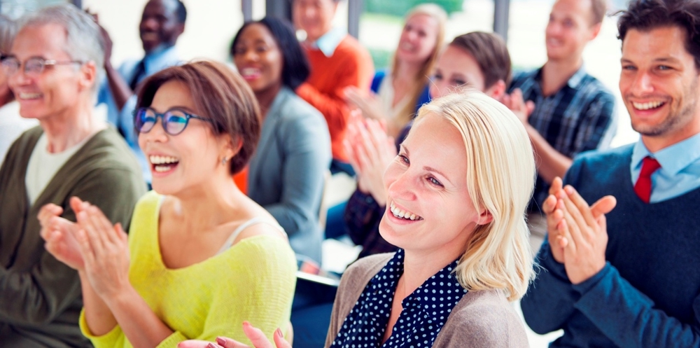 Group of people clapping at an event