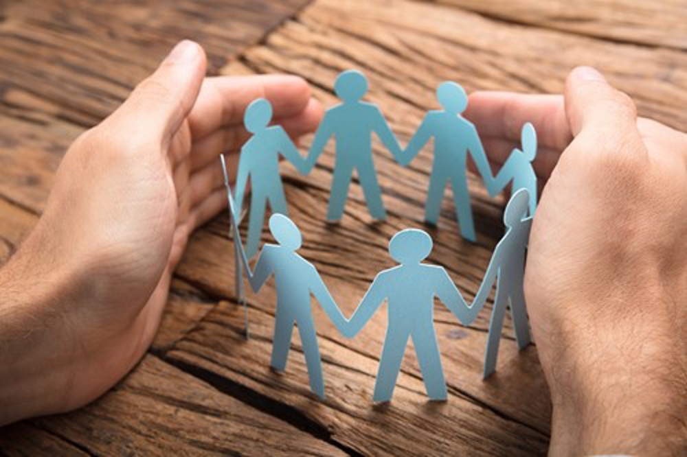 People holding hands paper chain