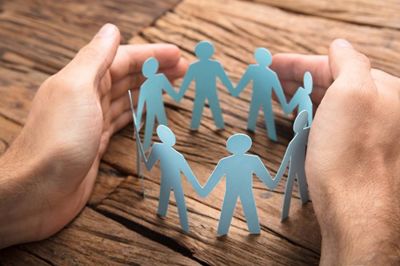 People holding hands paper chain