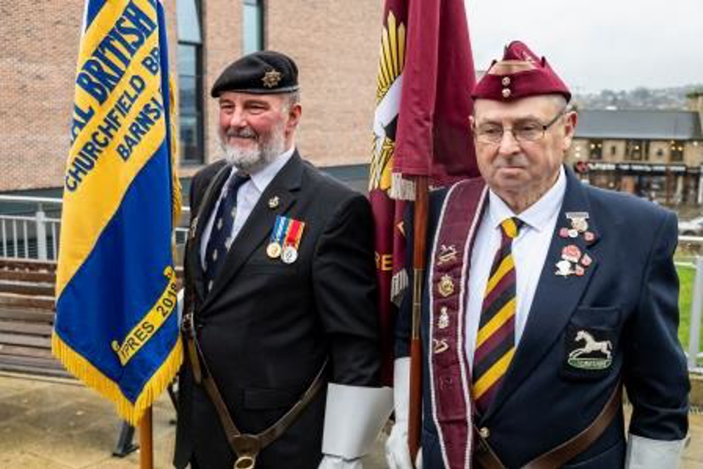 Armed Forces Community holding flags