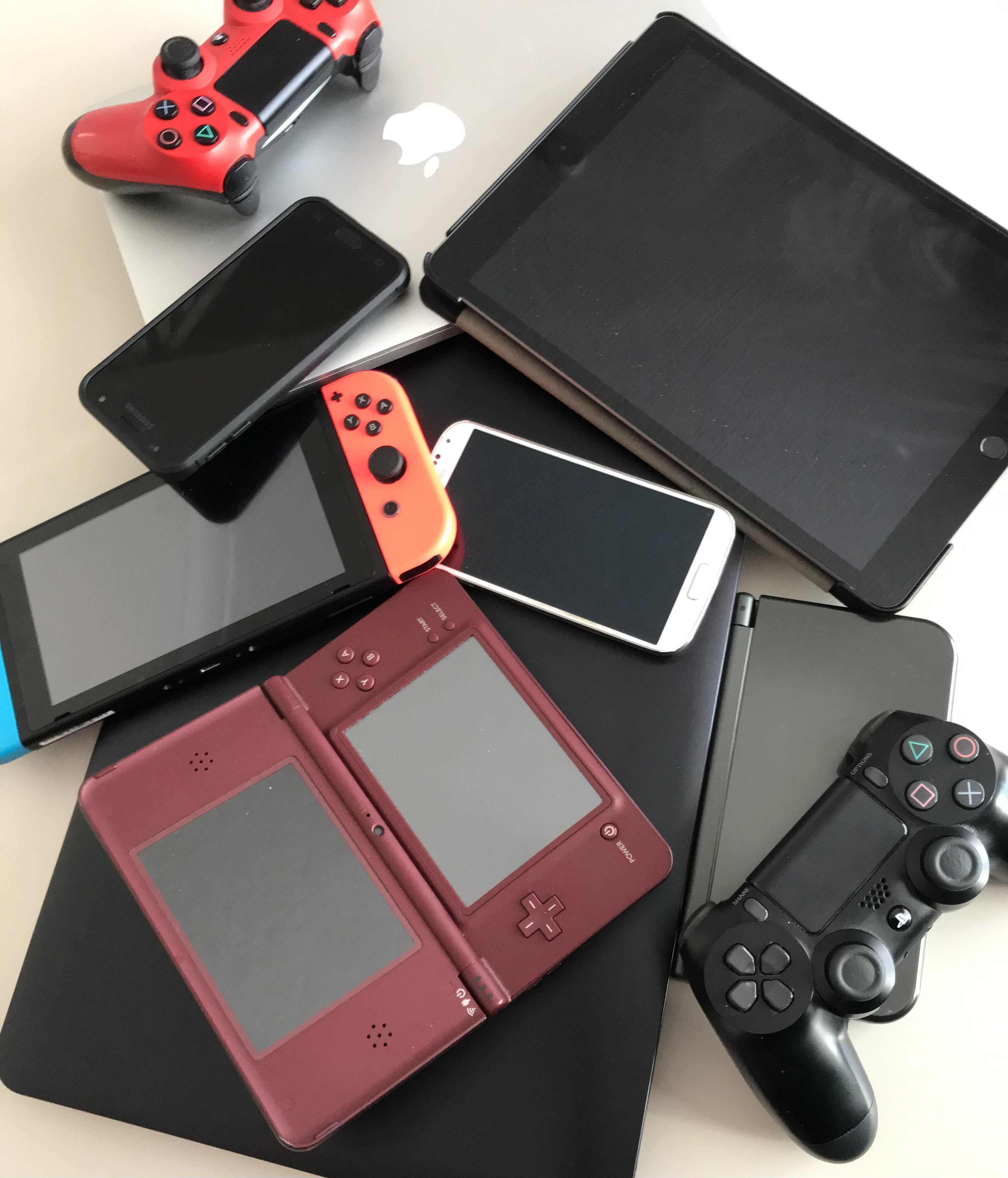 Photo of different digital devices: ipad, laptop, mobile phone and game consoles