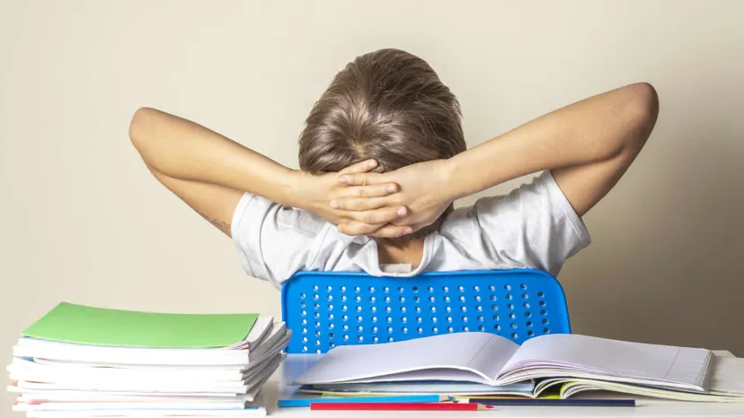 Boy with arms behind head