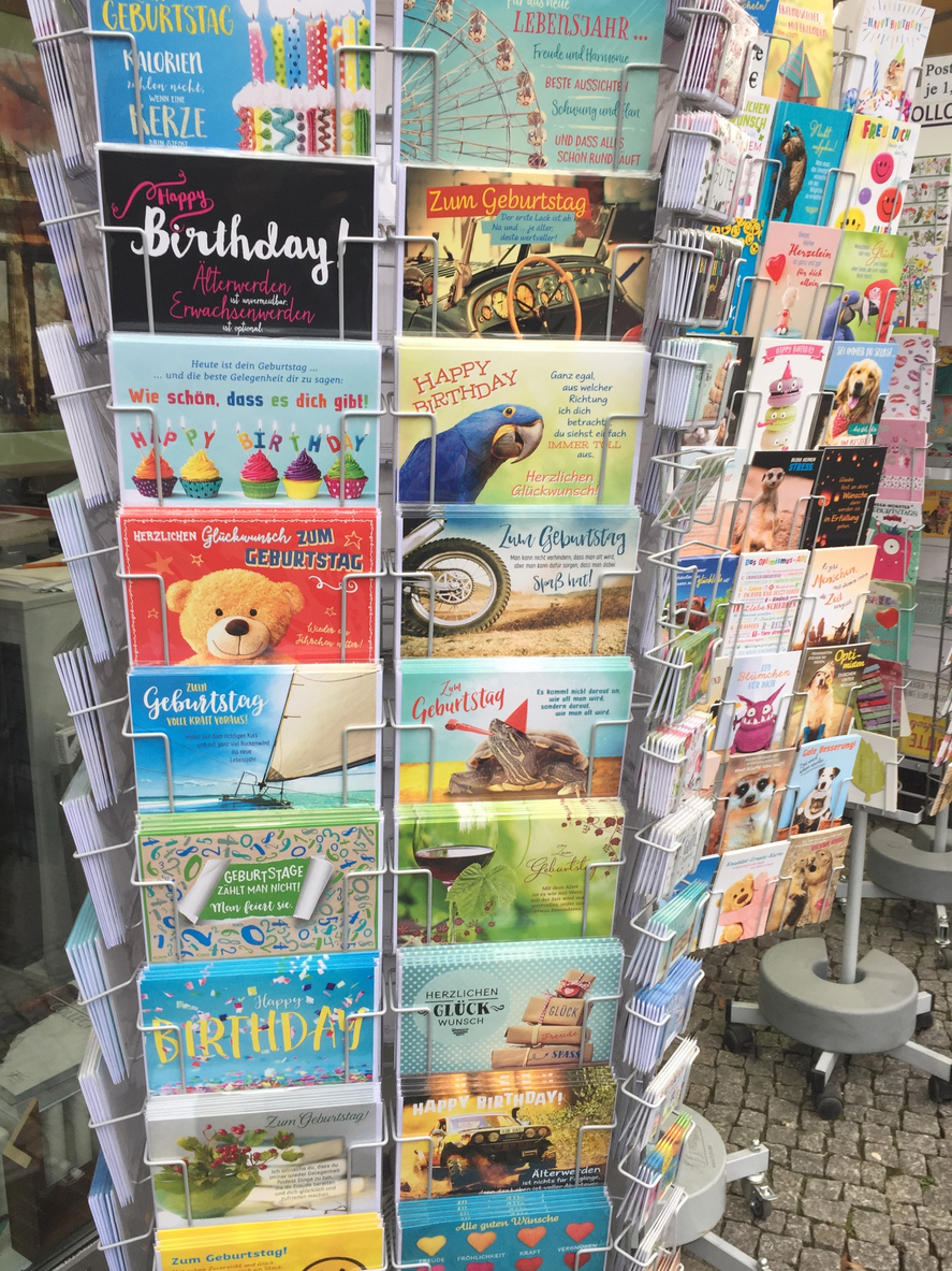 Greeting cards on a carousel outside a shop
