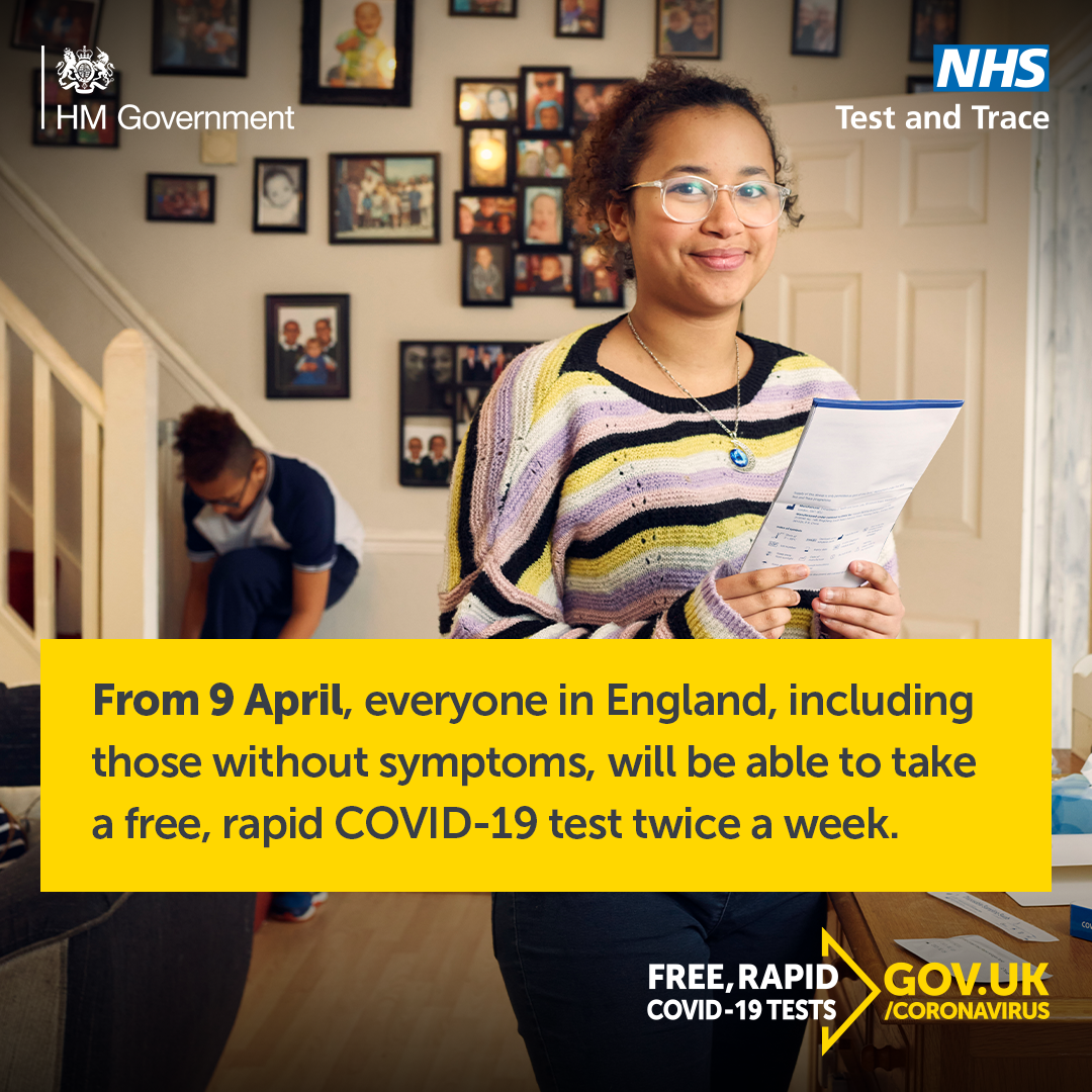 Smiling girl stood in her home, holding an information sheet for free, rapid COVID-19 tests available from 9 April
