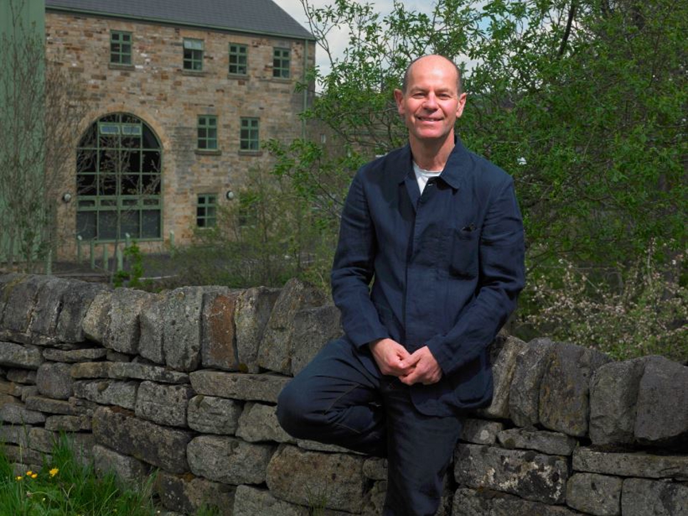 Charles outside a mill building