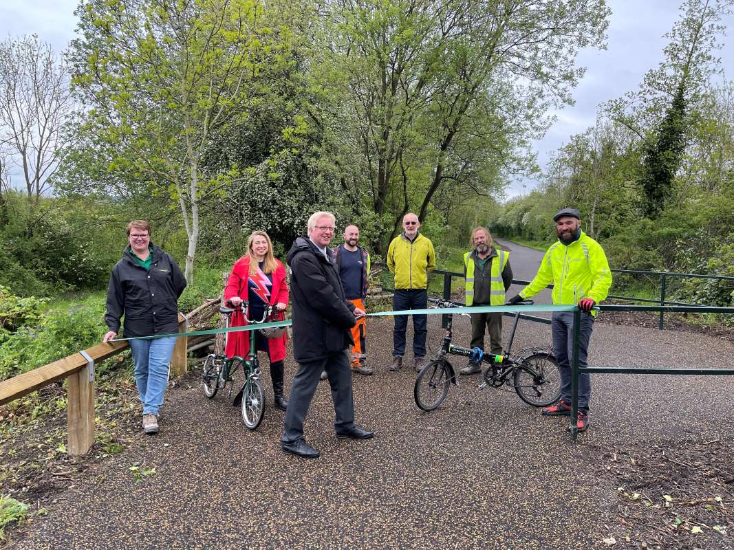 Cllr Wilson cutting the ribbon to reopen the Trans Pennine trail.