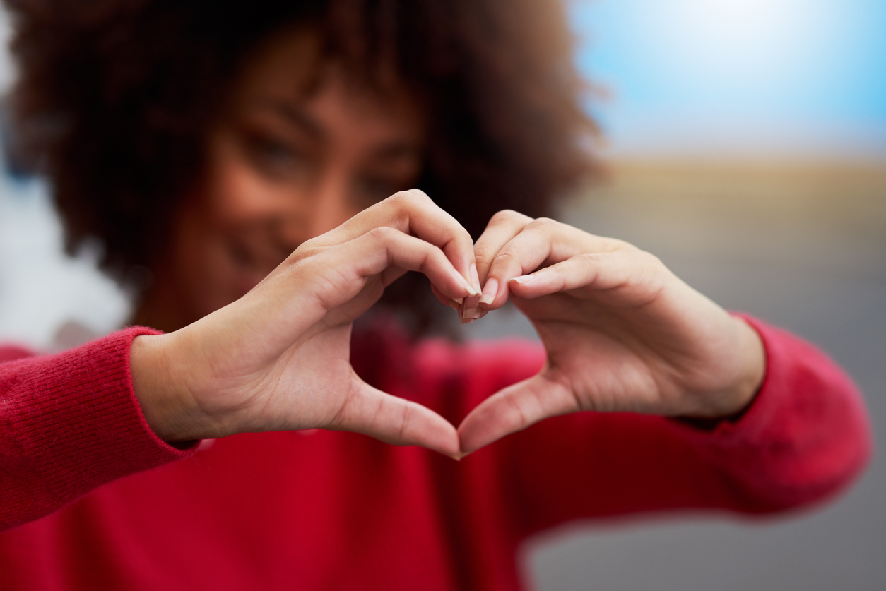 Woman making heart symbol with hands