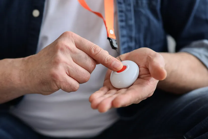 Person pressing telecare alarm button