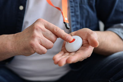 Person pressing telecare alarm button