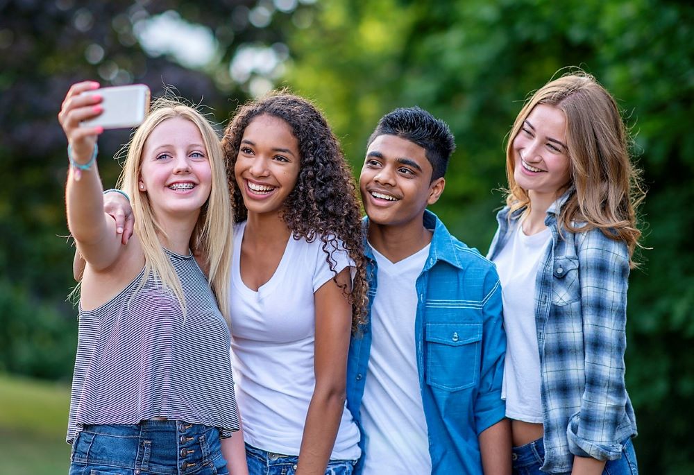 Four teenagers taking a selfie