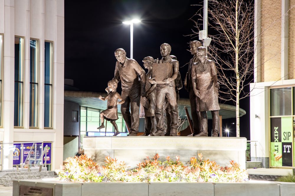 COVID memorial sculpture at night