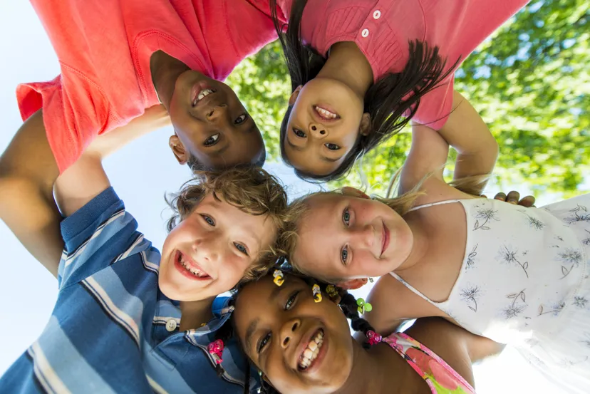 Group of five children smiling