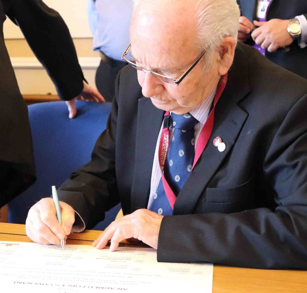 Man signing the Armed Forces Covenant