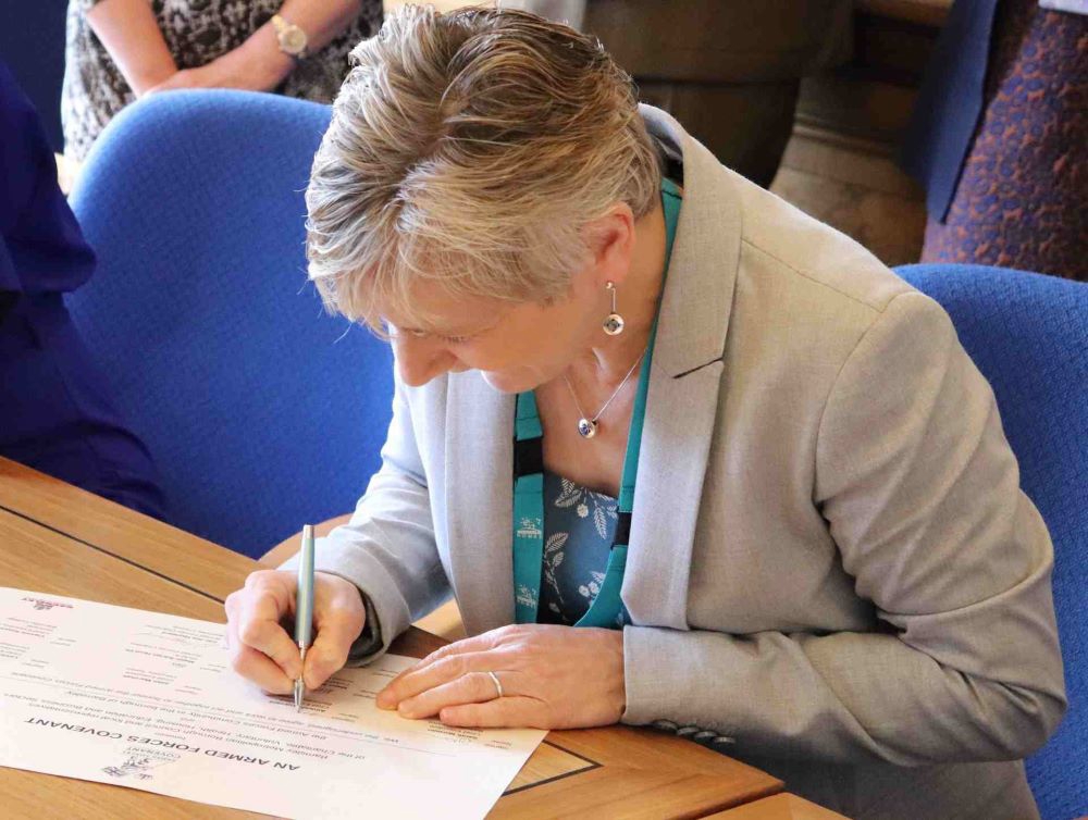 Amanda Garrard signing the Armed Forces Covenant