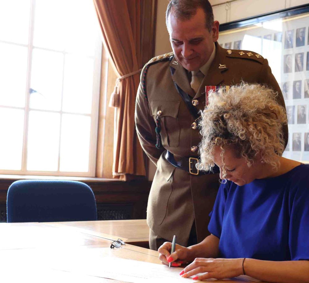 Lady signing the Armed Forces Covenant