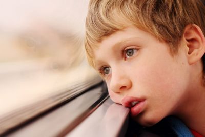 Boy looking out of a bus window