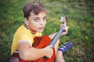 Deaf boy with a guitar