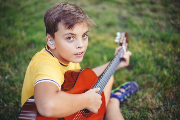 Deaf boy with a guitar