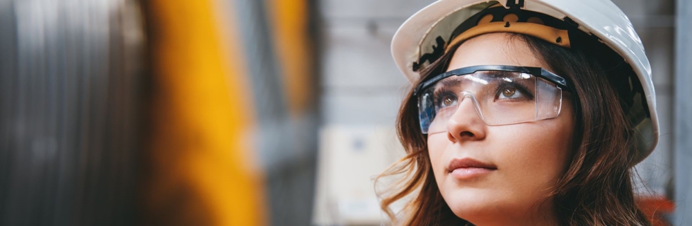 Young woman looking at machinery