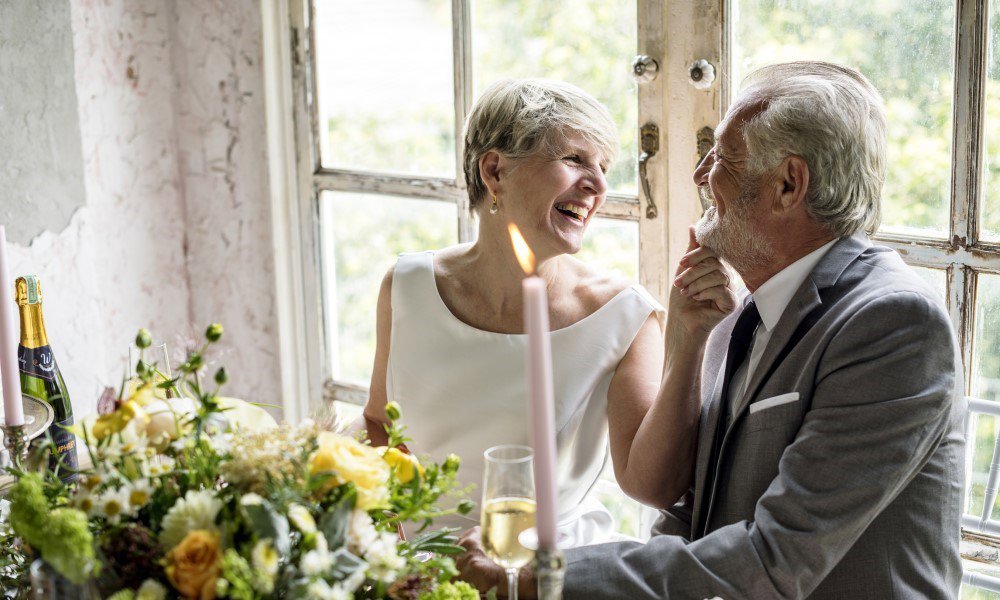 Senior couple sitting laughing together