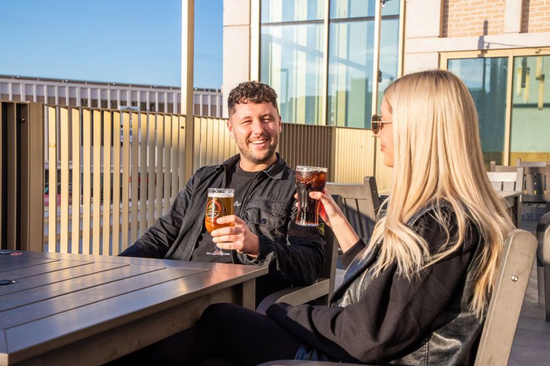 Couple having drinks on roof terrace at the market kitchen