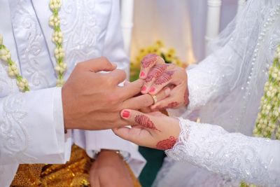 Couple sharing wedding rings