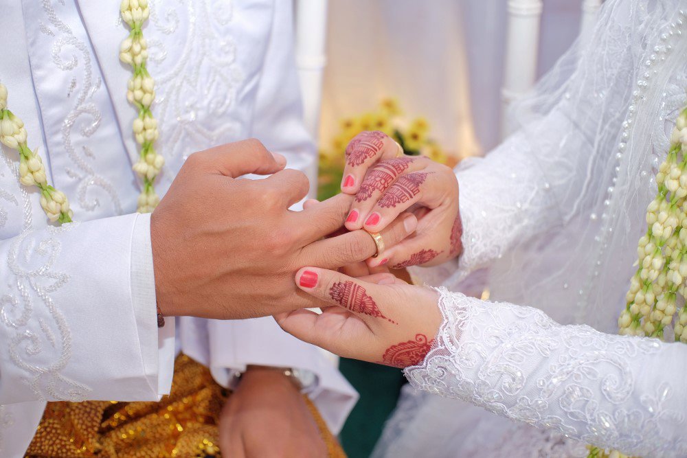 Couple sharing wedding rings