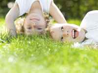Two children playing on grass
