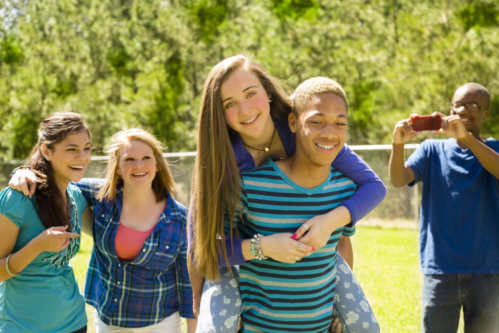 Group of teenagers on tennis court