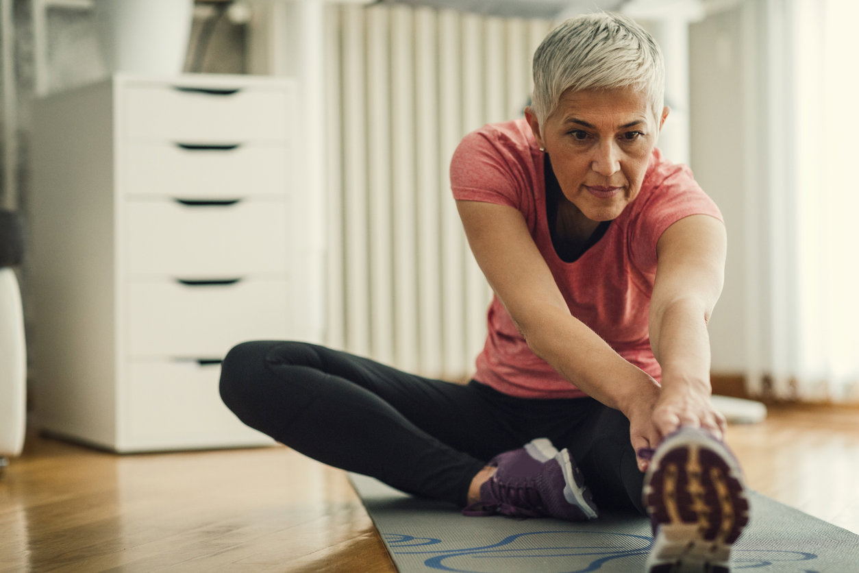 Lady stretching on a yoga mat