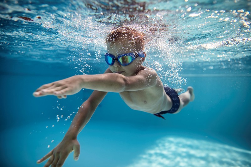 Boy swimming under water