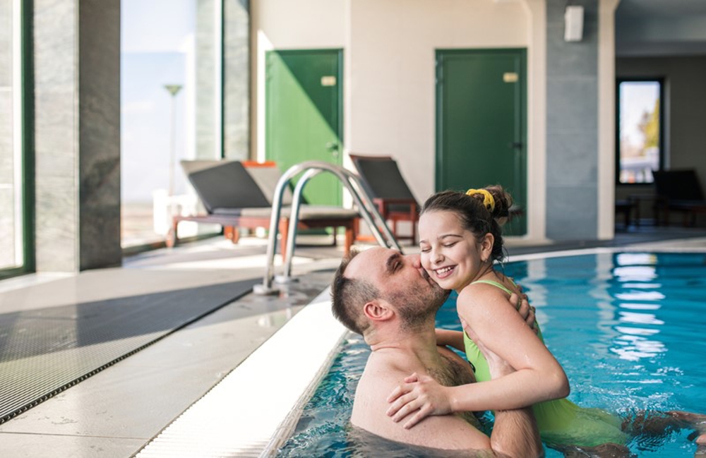 Dad and daughter in swimming pool