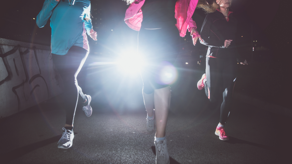 Women running in the dark at night