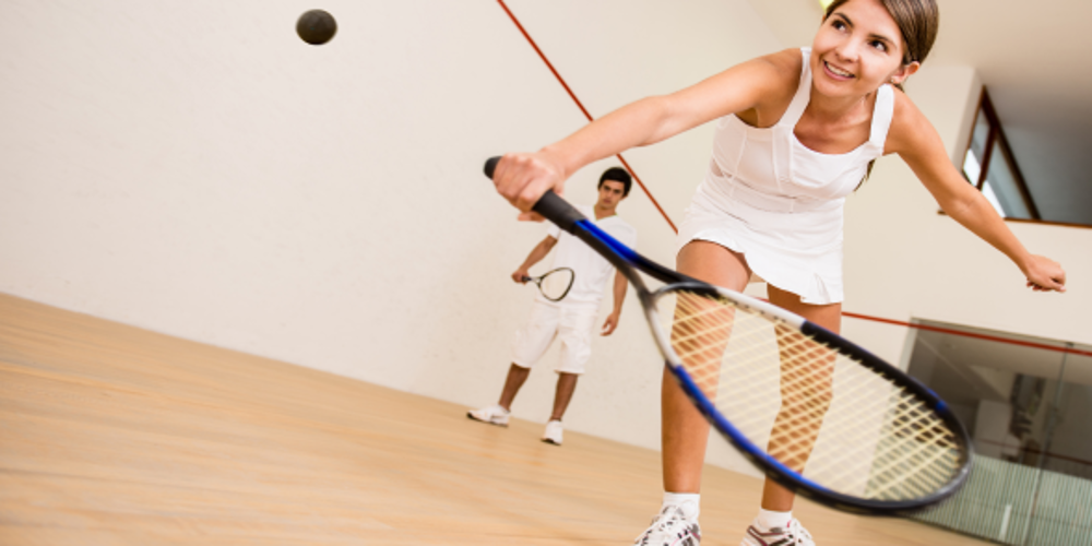 Couple playing squash