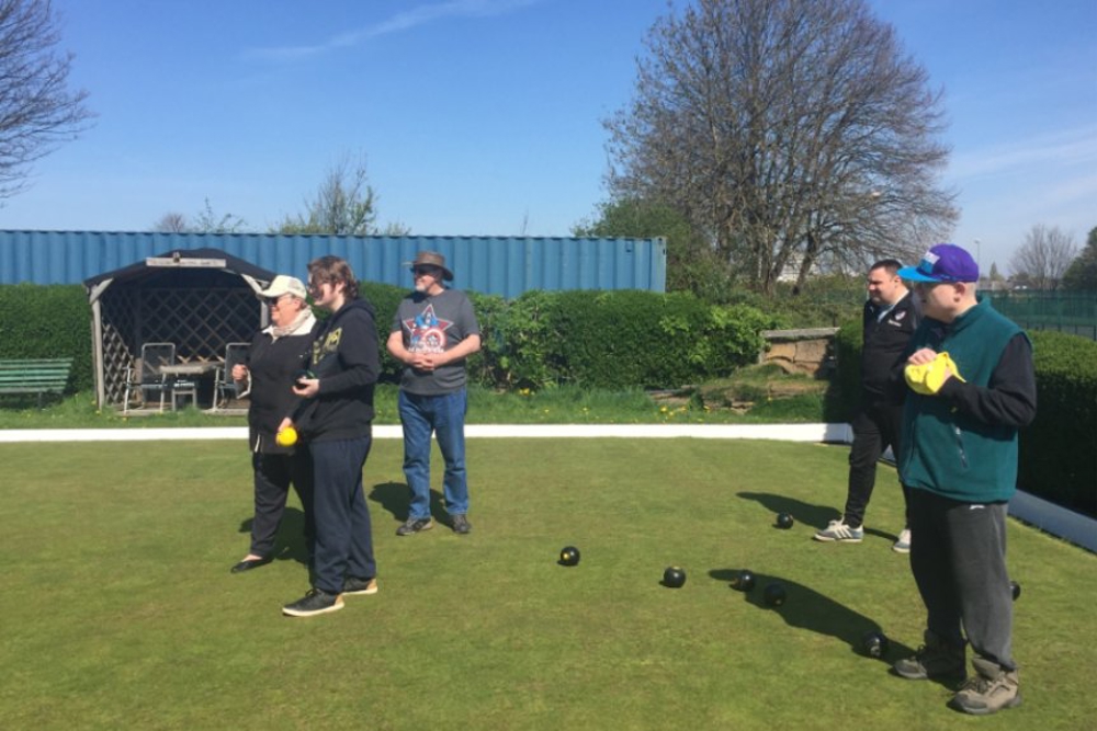 People playing bowls on a bowling green