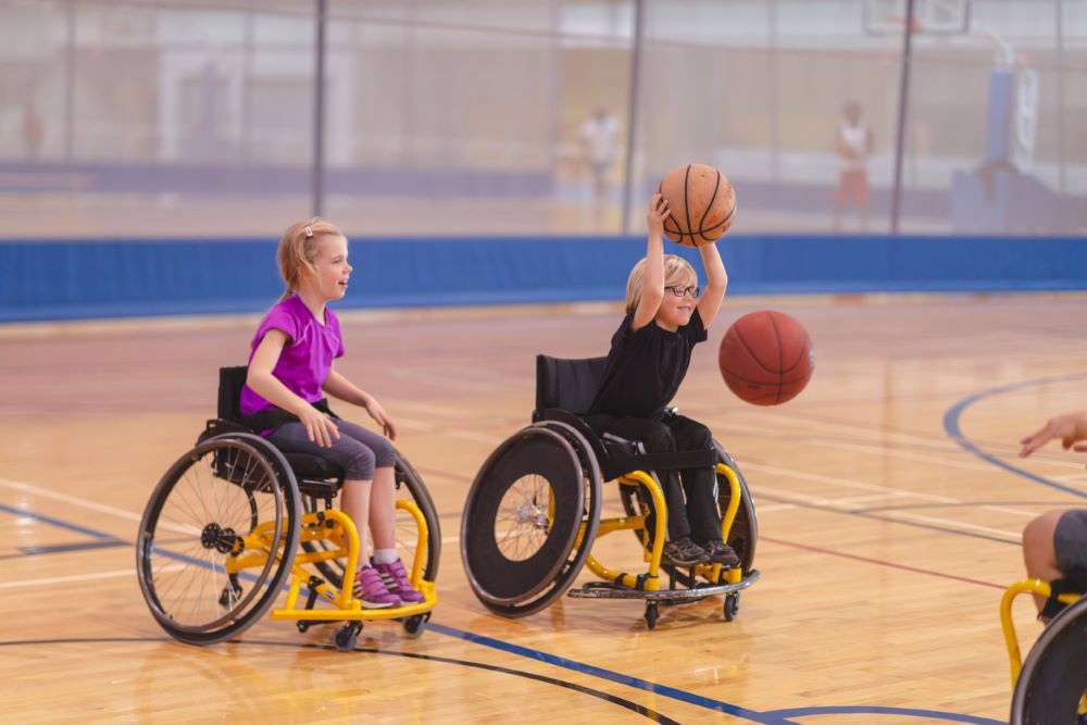 2 children in wheelchairs playing basketball