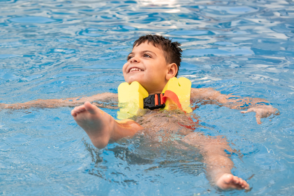 Disabled boy swimming