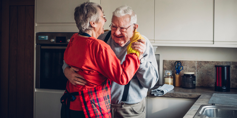 Older couple dancing in the kitchen