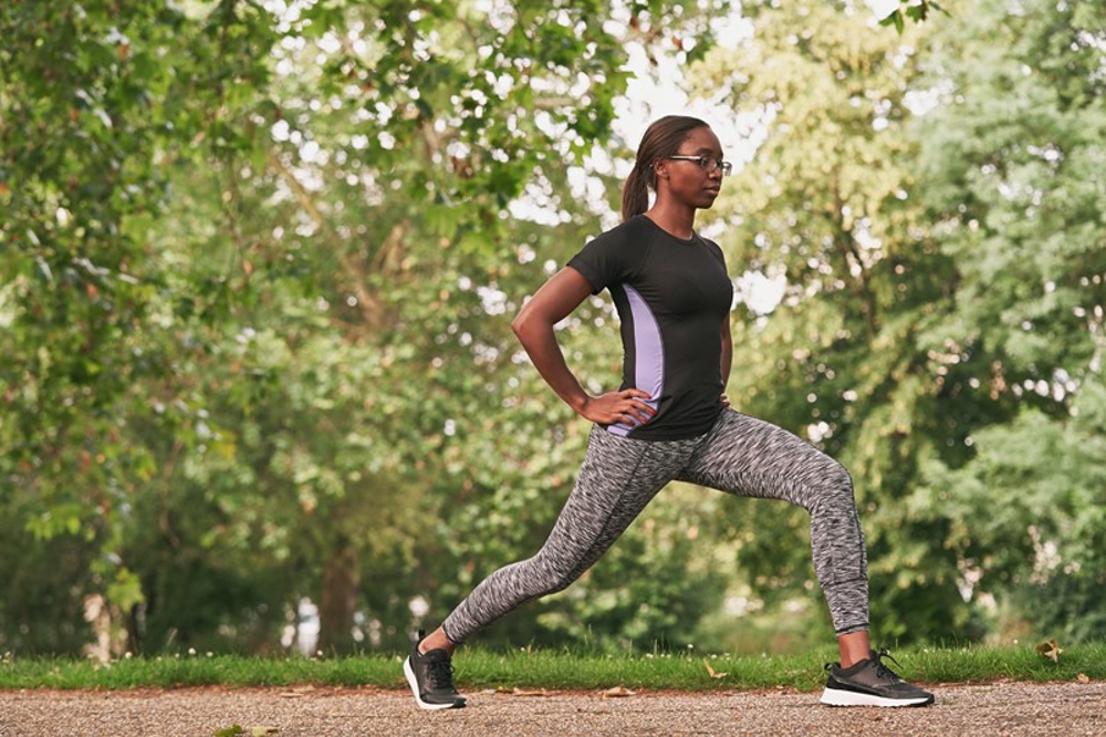 Woman stretching before a run in the park