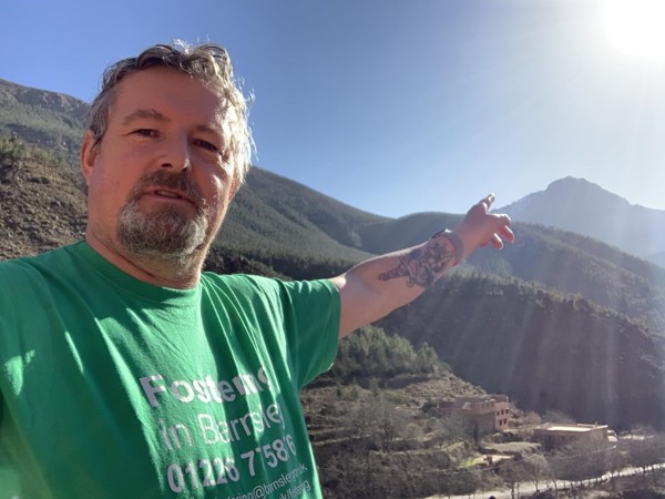 Mark Slater wearing fostering shirt at Mount Toubkal
