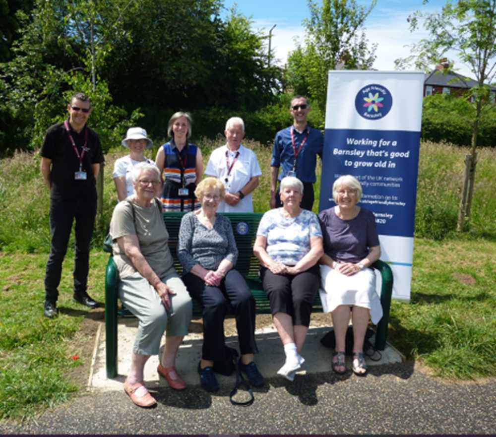 People sat on a bench in Darton park