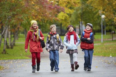 Four children walking in a park