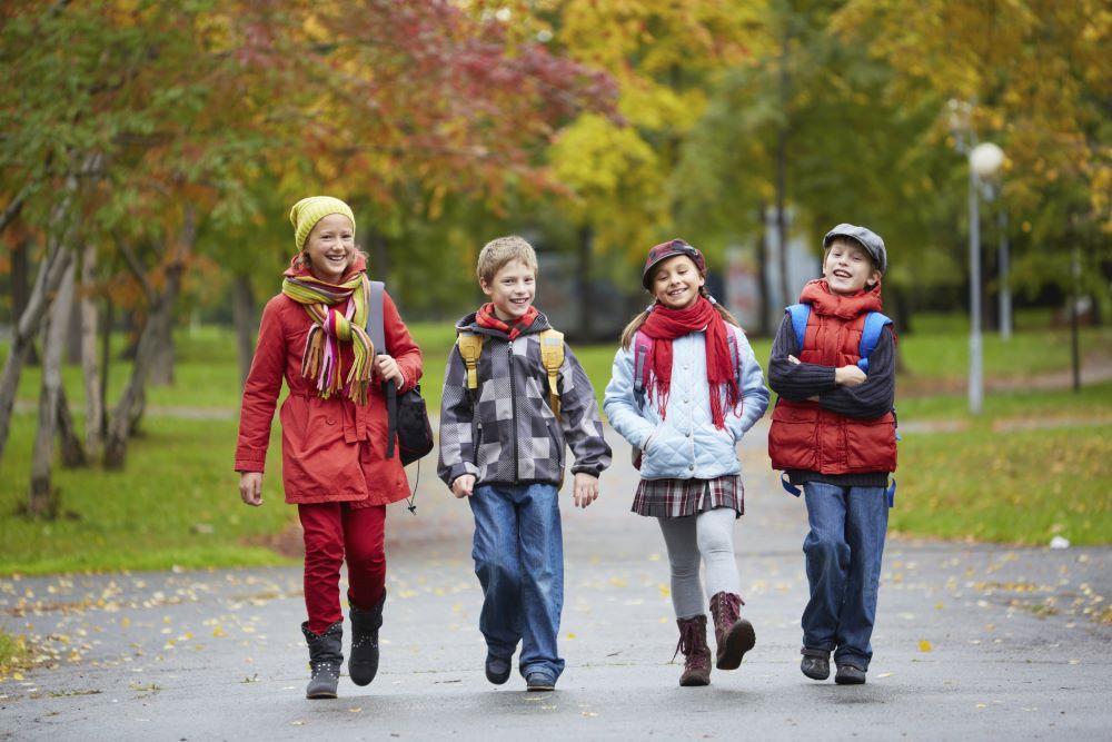 Four children walking in a park