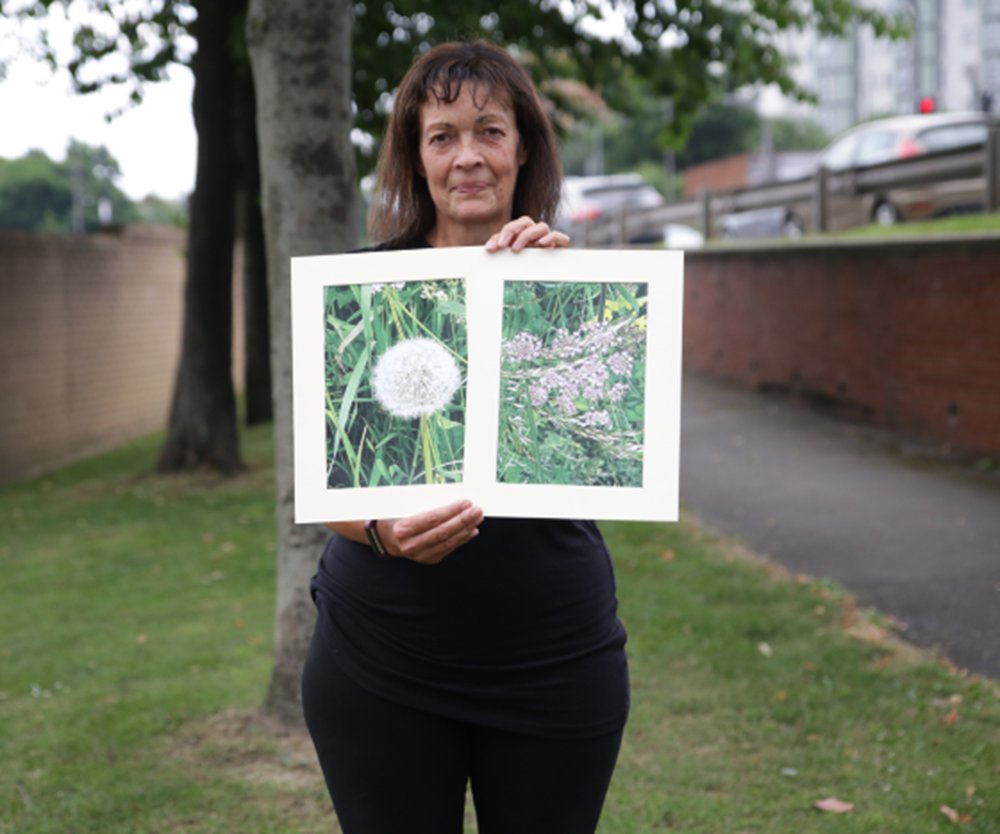 Sue holding artwork